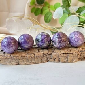 Charoite sphere that promotes spiritual awakening, intuition, and personal transformation, for crystal healing, meditation.