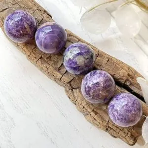 Charoite sphere that promotes spiritual awakening, intuition, and personal transformation, for crystal healing, meditation.