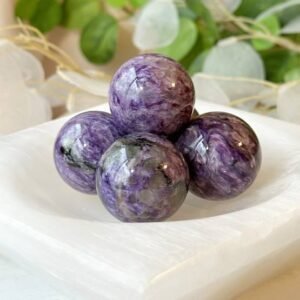 Charoite sphere that promotes spiritual awakening, intuition, and personal transformation, for crystal healing, meditation.