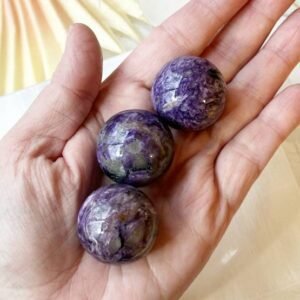 Charoite sphere that promotes spiritual awakening, intuition, and personal transformation, for crystal healing, meditation.