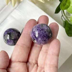 Charoite sphere that promotes spiritual awakening, intuition, and personal transformation, for crystal healing, meditation.
