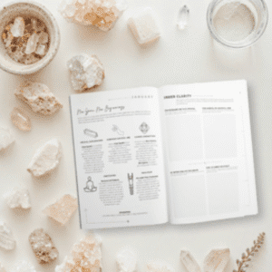 Open planner surrounded by natural crystals, candle, and journal accessories.