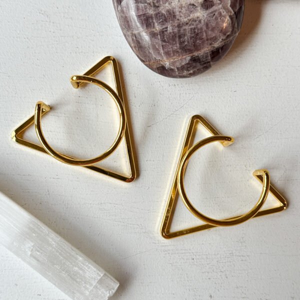 Gold geometric crystal sphere display stands with square or triangular bases.